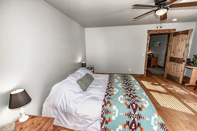 bedroom featuring hardwood / wood-style floors and ceiling fan