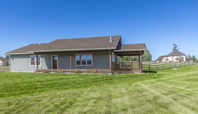 rear view of house with a yard