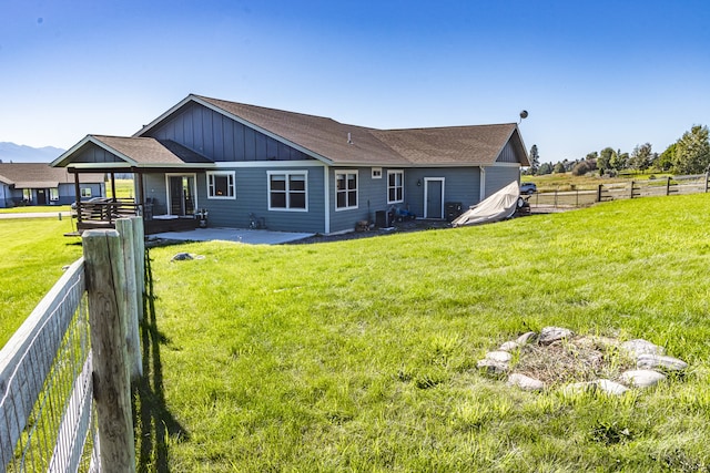 back of house with a lawn and a patio area