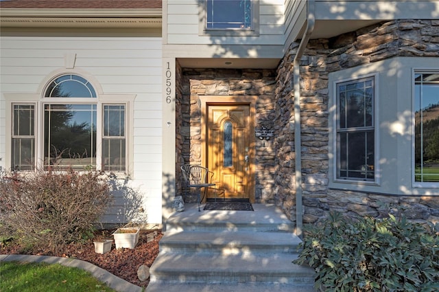 view of exterior entry featuring stone siding