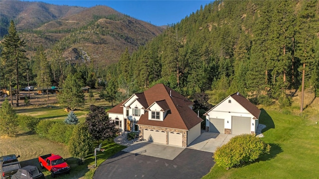 bird's eye view featuring a forest view and a mountain view