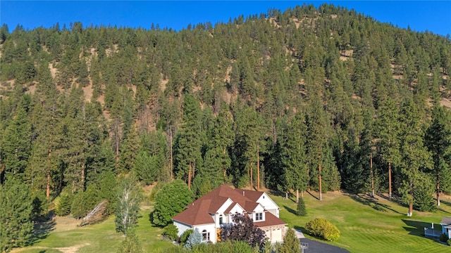 aerial view featuring a wooded view