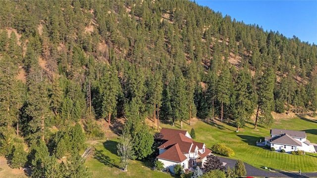 birds eye view of property with a forest view