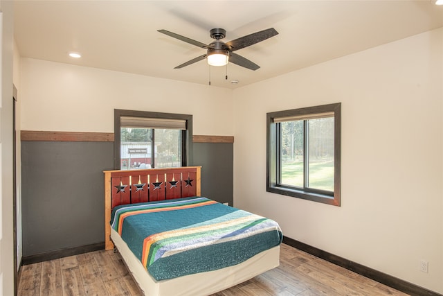 bedroom with ceiling fan and wood-type flooring