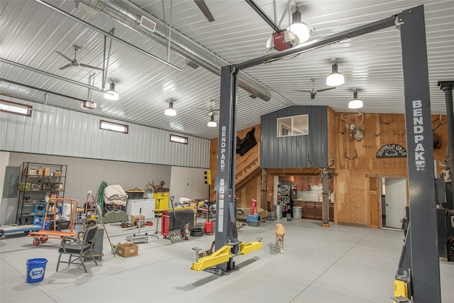 garage with wooden walls and ceiling fan