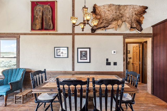 dining room with a chandelier and wood-type flooring