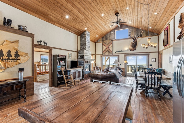 living room with hardwood / wood-style flooring, high vaulted ceiling, and wood ceiling