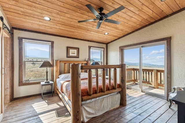 bedroom featuring access to exterior, ceiling fan, a mountain view, light hardwood / wood-style floors, and lofted ceiling