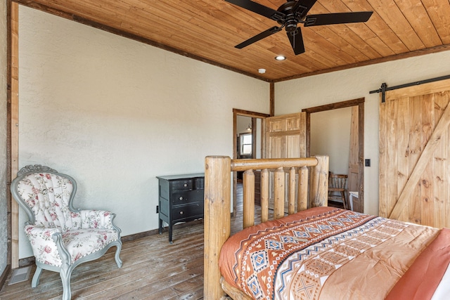 bedroom featuring ornamental molding, wood ceiling, ceiling fan, wood-type flooring, and a barn door