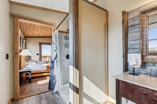 bathroom with hardwood / wood-style floors, walk in shower, and wood ceiling