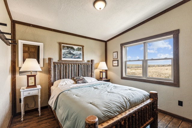 bedroom featuring dark hardwood / wood-style floors, a textured ceiling, and vaulted ceiling