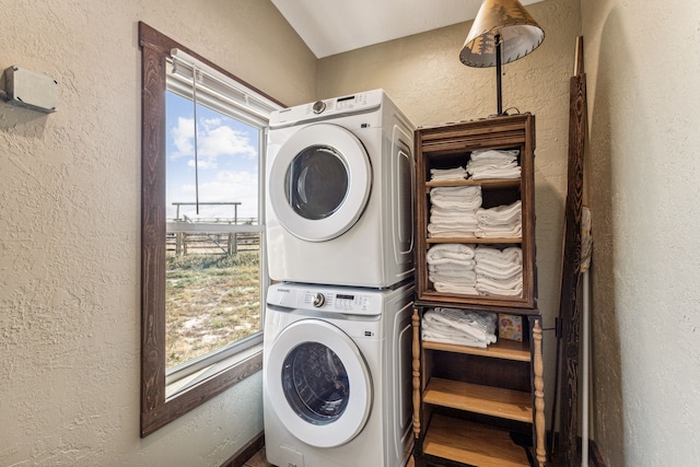 laundry area with stacked washer and clothes dryer