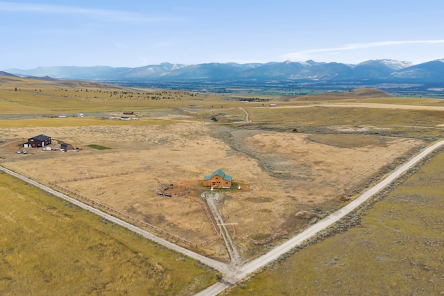 drone / aerial view featuring a mountain view and a rural view