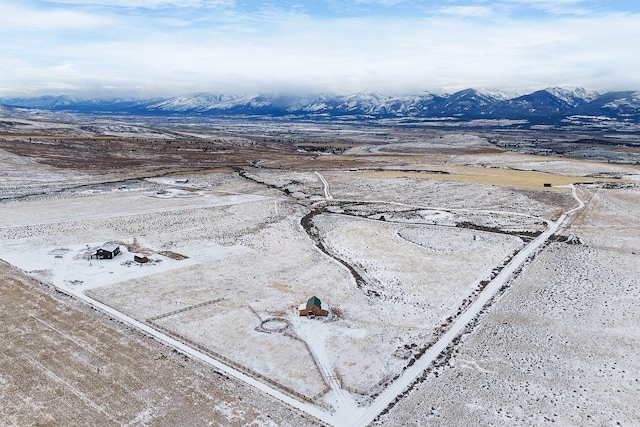 snowy aerial view with a mountain view