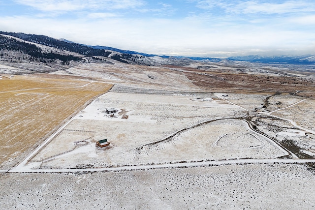 snowy aerial view with a mountain view