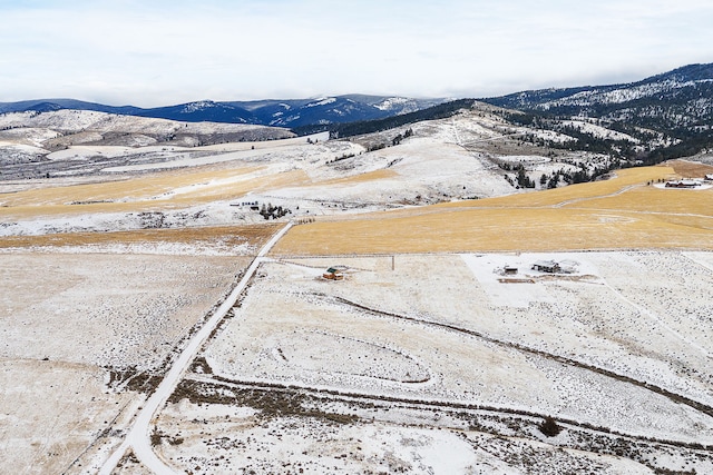 snowy aerial view with a mountain view