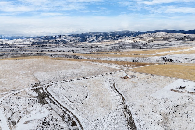 snowy aerial view featuring a mountain view