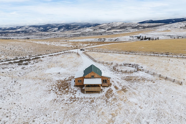 snowy aerial view featuring a mountain view