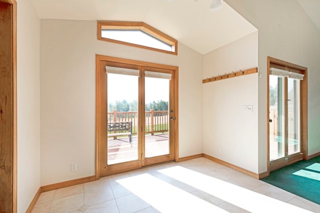 doorway to outside featuring lofted ceiling and light tile patterned floors