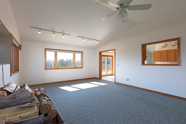 carpeted spare room featuring lofted ceiling, ceiling fan, and track lighting