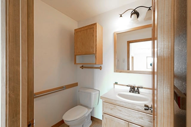 bathroom with hardwood / wood-style flooring, vanity, and toilet