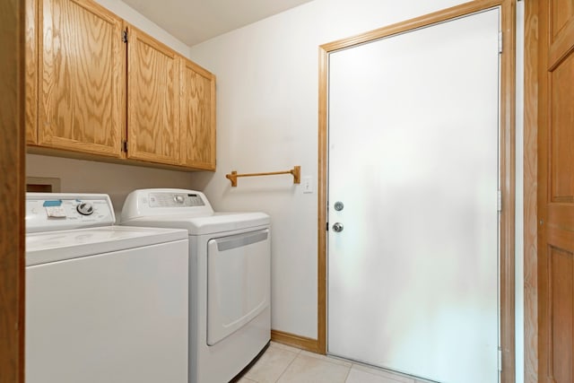 laundry room featuring light tile patterned floors, cabinets, and independent washer and dryer