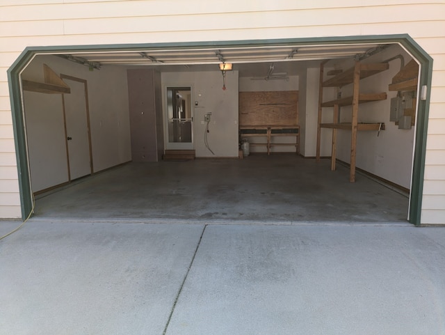 garage with a garage door opener and electric panel