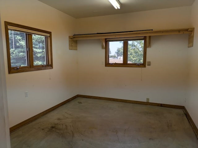 unfurnished room with plenty of natural light and concrete floors