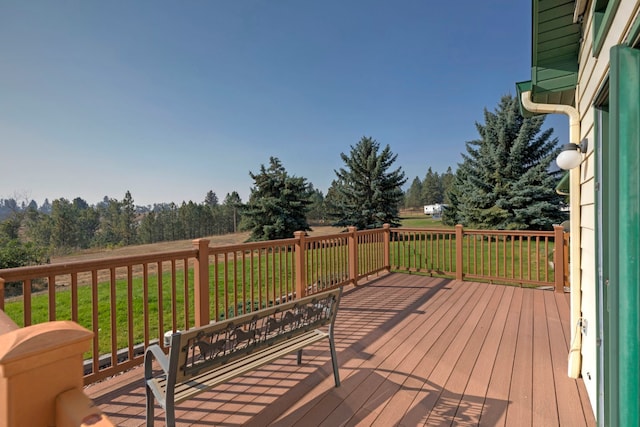 wooden terrace with a lawn