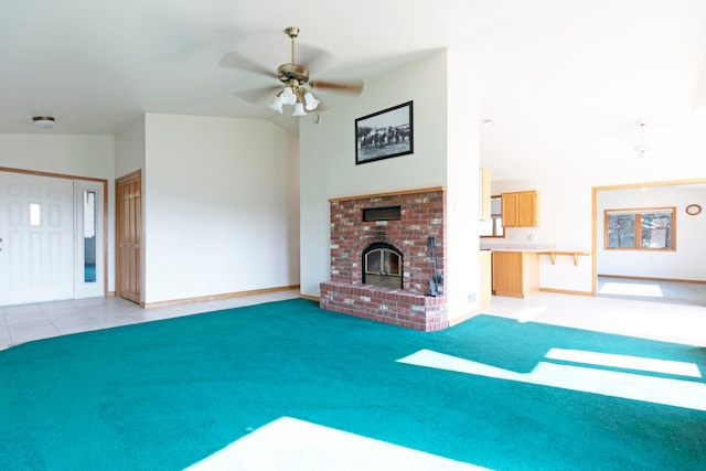 unfurnished living room featuring lofted ceiling, ceiling fan, light colored carpet, and a brick fireplace