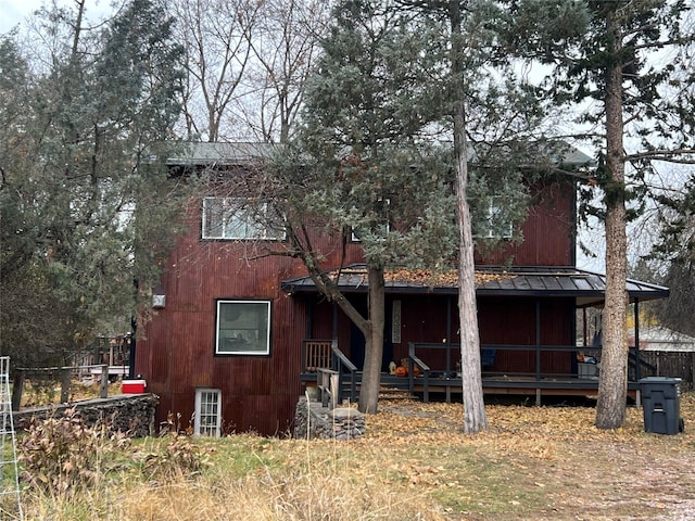 back of house featuring a porch