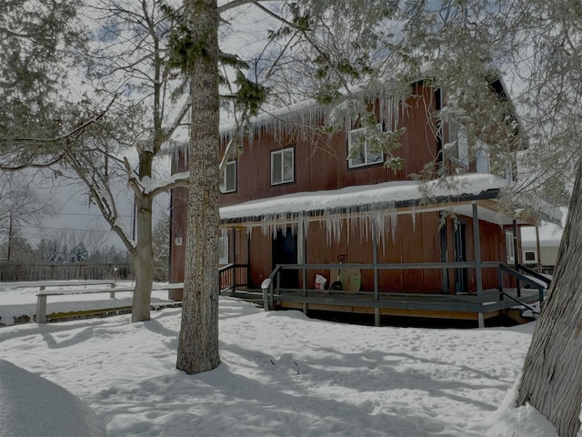 view of snow covered rear of property