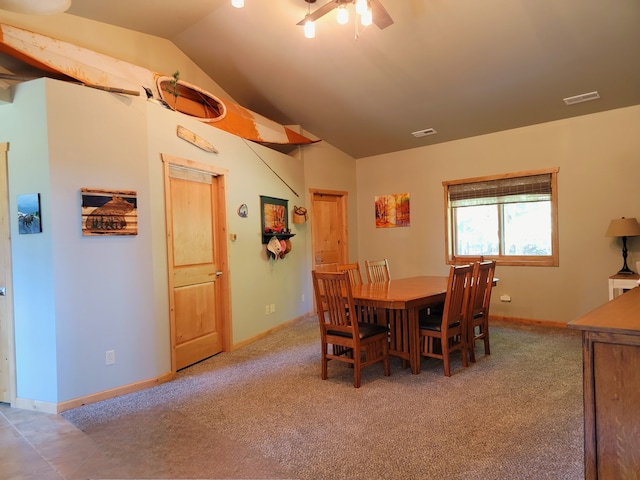 carpeted dining space featuring vaulted ceiling and ceiling fan