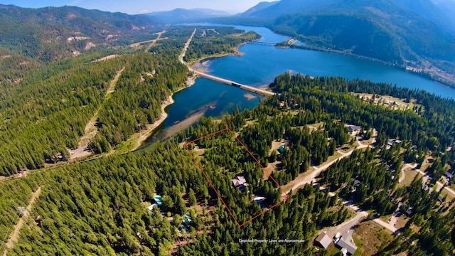 drone / aerial view featuring a water and mountain view