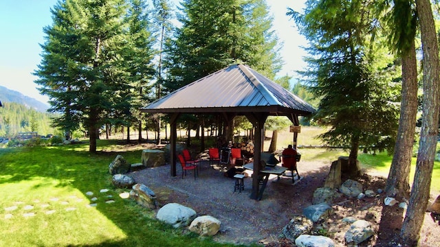 surrounding community with a gazebo, a yard, and a mountain view