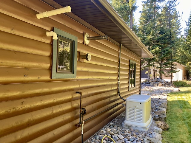 view of side of property featuring faux log siding