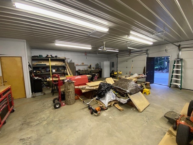 garage with a workshop area and white refrigerator