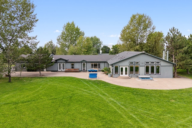 rear view of property with a yard and a patio area