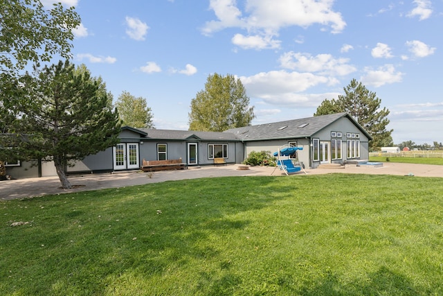 rear view of house featuring a yard, a patio area, and french doors