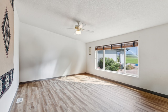 unfurnished room featuring a textured ceiling, ceiling fan, and light hardwood / wood-style floors