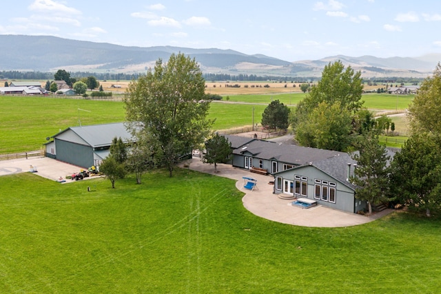 birds eye view of property with a mountain view and a rural view