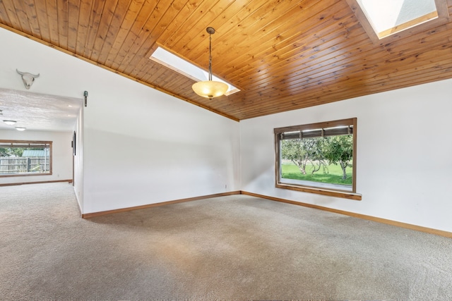 carpeted empty room with vaulted ceiling with skylight, wood ceiling, and ornamental molding