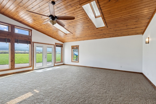 interior space with ceiling fan, wood ceiling, and vaulted ceiling with skylight