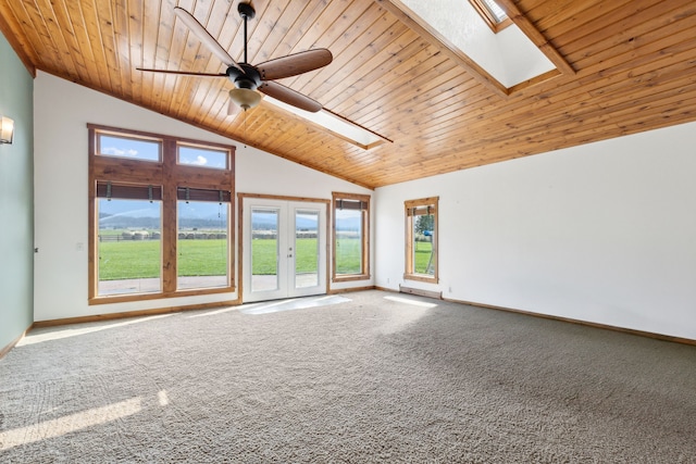 carpeted spare room with wood ceiling, ceiling fan, and lofted ceiling with skylight