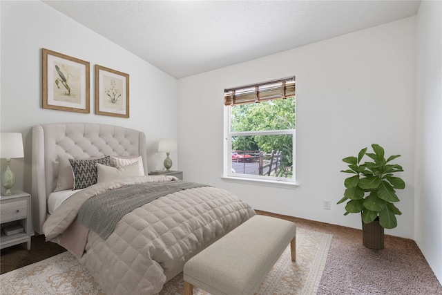 bedroom with lofted ceiling and light carpet