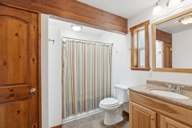 bathroom featuring curtained shower, tile patterned flooring, toilet, and vanity