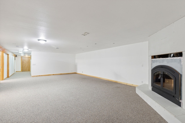 unfurnished living room with light colored carpet