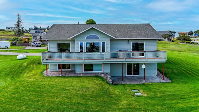 rear view of house with a yard and a patio area