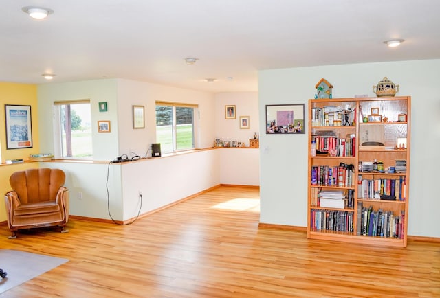 living area with a healthy amount of sunlight and light hardwood / wood-style floors