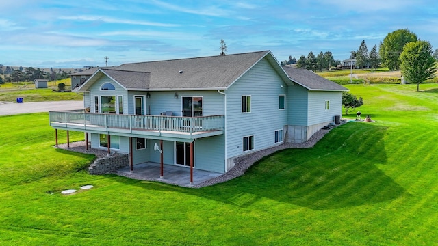 back of house featuring a balcony, a lawn, and a patio